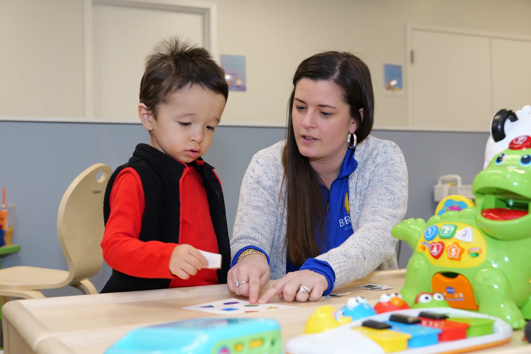 Bierman therapist guiding a child through a fine motor activity during occupational therapy